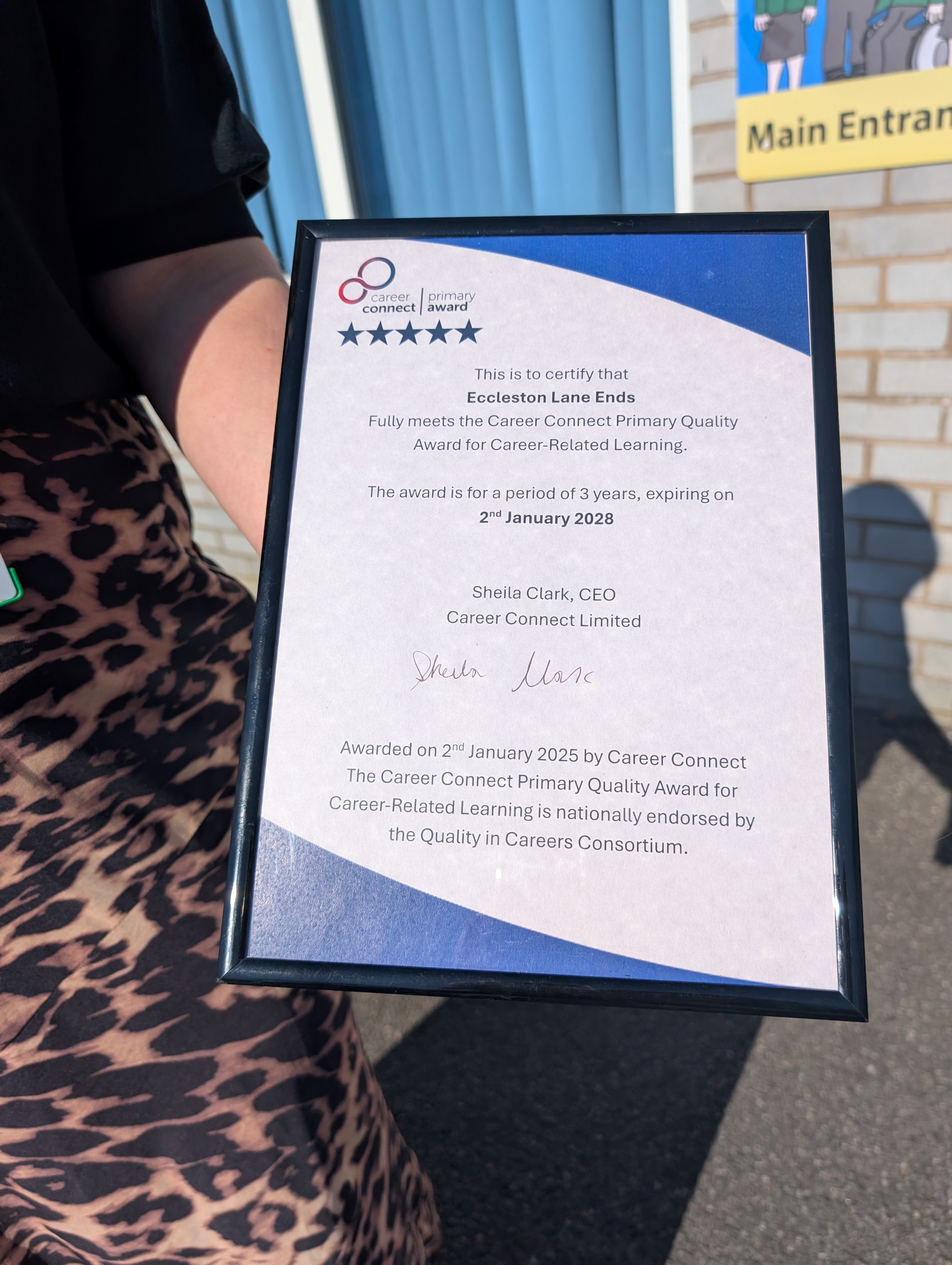 Eccleston Lane Ends Headteacher holding the Career Connect Primary Award Certificate with the date of their award, signed by the CEO of Career Connect.